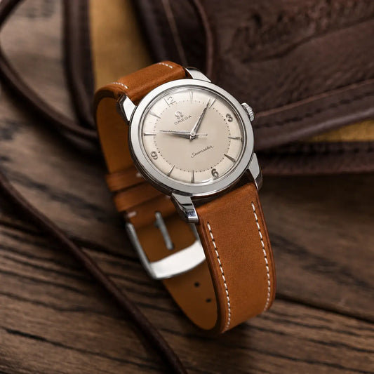 20mm Brown Italian Pueblo leather watch strap on vintage Omega Seamaster watch, handcrafted leather band with soft texture and classic white stitching.
