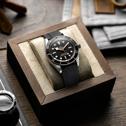 22mm black rubber watch strap on Tudor Black Bay Fifty-Eight, premium textured sport watch band displayed in watch box with durable comfort and modern dive styling.