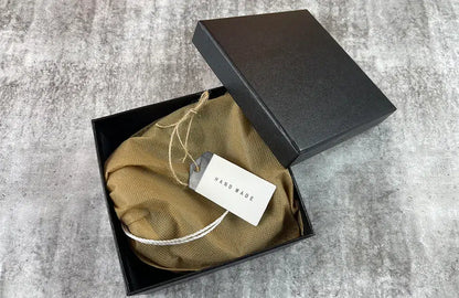 Brown leather men’s belt packaged with a black presentation box for gifting and storage.