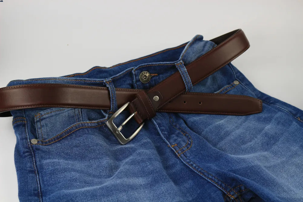 a brown belt on blue jeans