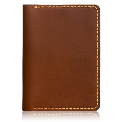 An open-flat view of a tan full-grain leather bifold cardholder against a white background, highlighting the interior's dual-pocket capacity with a stack of folded banknotes and a credit card secured by precision artisanal stitching.