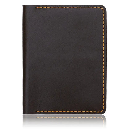 A vertical studio shot of a handcrafted dark brown crazy horse leather card holder featuring precision yellow contrast stitching and hand-burnished edges, isolated on a white background with a subtle reflection.