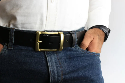 a person wearing a leather belt and jeans