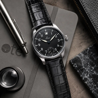 Genuine black crocodile leather watch band with tan underside lining, featuring a polished silver buckle on a classic white dial Laco timepiece.