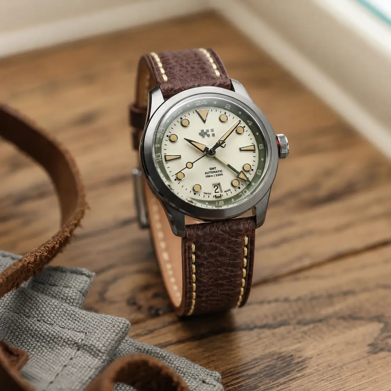 20mm Chestnut brown leather watch strap paired with Christopher Ward GMT watch, handcrafted premium watch band with textured leather and contrast stitching.