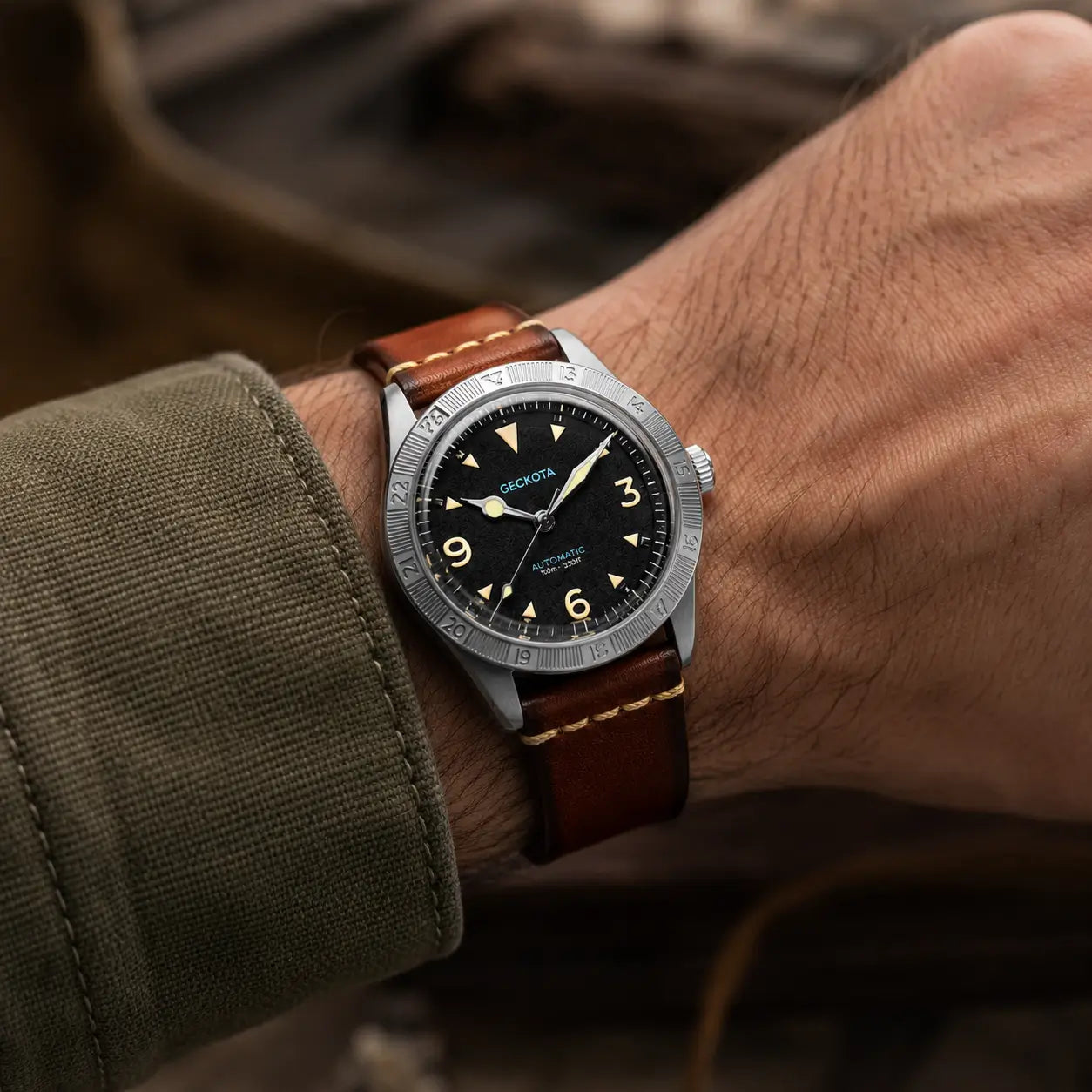 20mm brown Italian leather watch strap on Geckota automatic field watch, handcrafted vintage leather watch band with contrast stitching worn on wrist.
