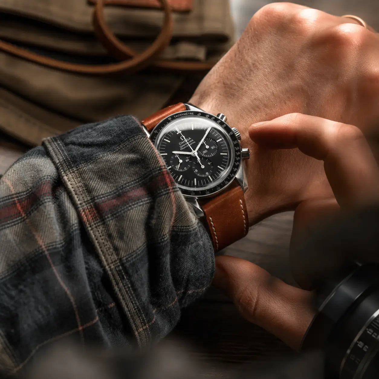 20mm Brown Italian Pueblo leather watch strap worn with Omega Speedmaster on wrist, handcrafted leather watch band with classic stitching and timeless design.