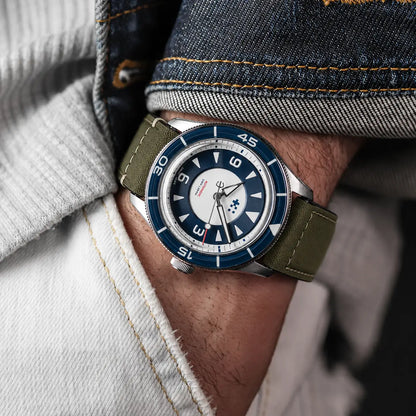 22mm olive green canvas watch strap on Aquastar dive watch worn on wrist, rugged military-style watch band with durable stitching and vintage outdoor appeal.