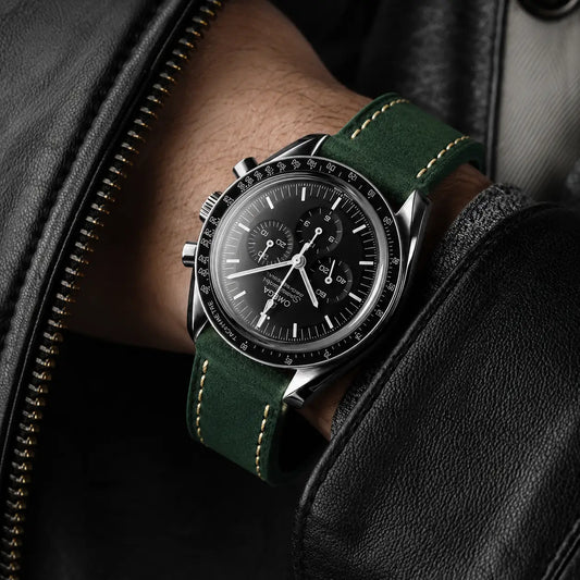 22mm green Italian leather watch strap on Omega Speedmaster chronograph watch, handcrafted premium suede leather watch band with contrast stitching worn on wrist.