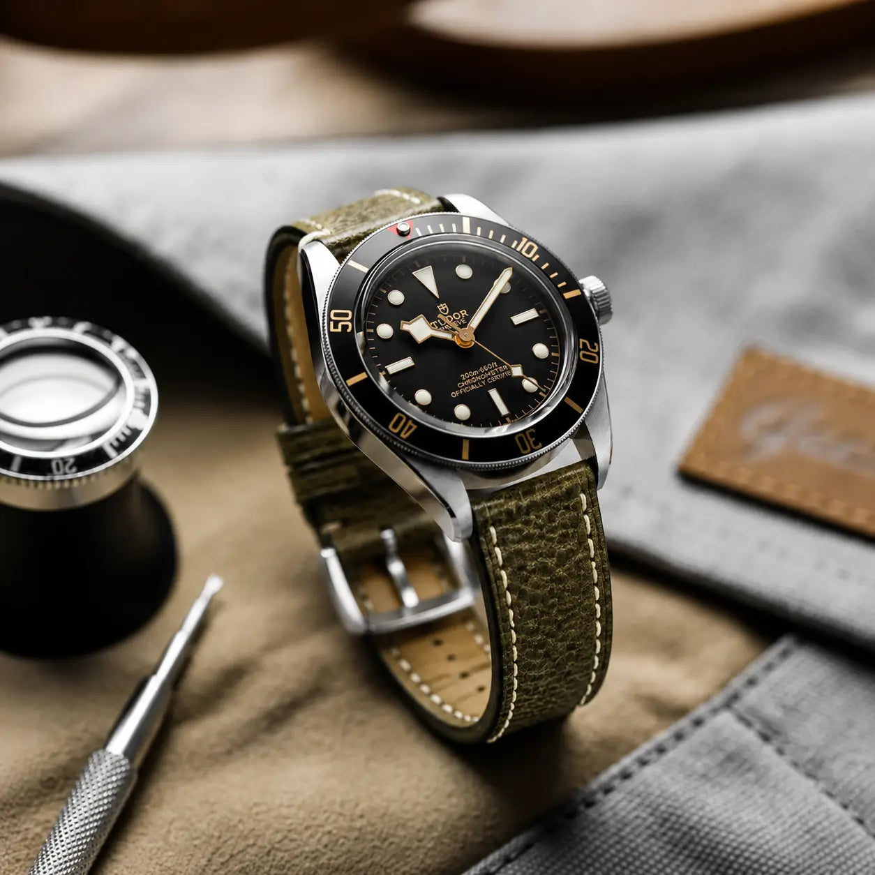 22mm Olive green leather watch strap paired with Tudor Black Bay, handcrafted premium watch band with contrast stitching and textured vintage leather finish.