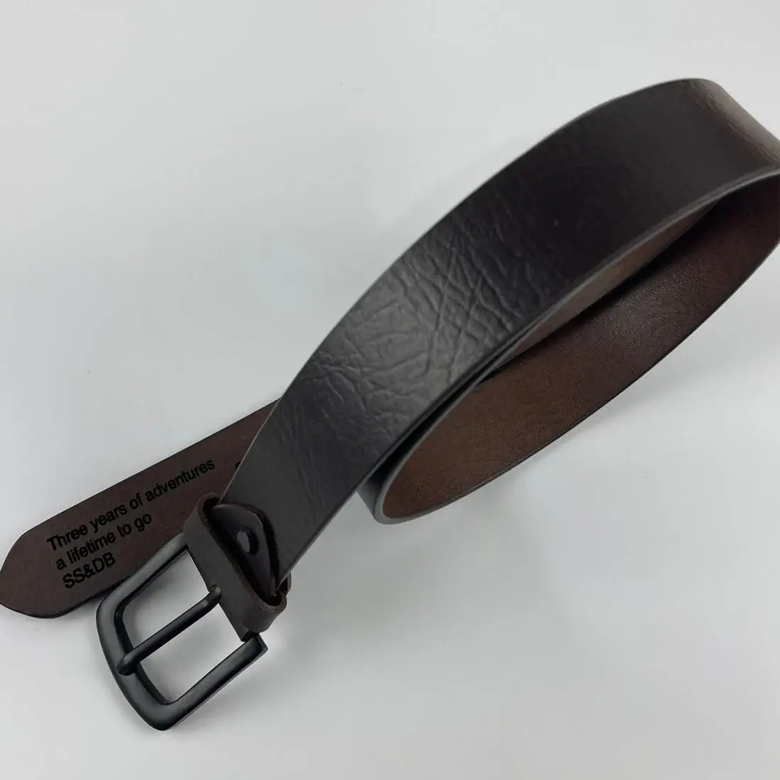 Personalised black leather belt with engraved message on inside and classic black buckle
