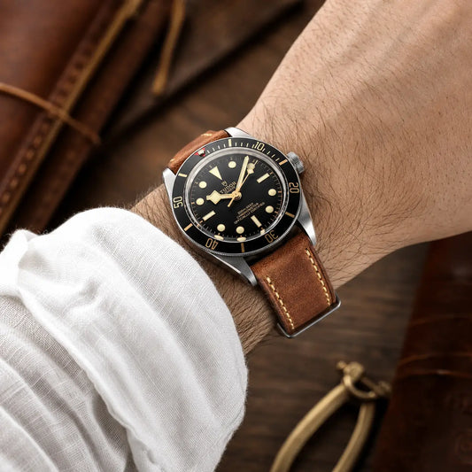 22mm Brown leather watch strap fitted on Tudor Black Bay watch on wrist, premium handcrafted watch band with classic stitching and vintage appeal.