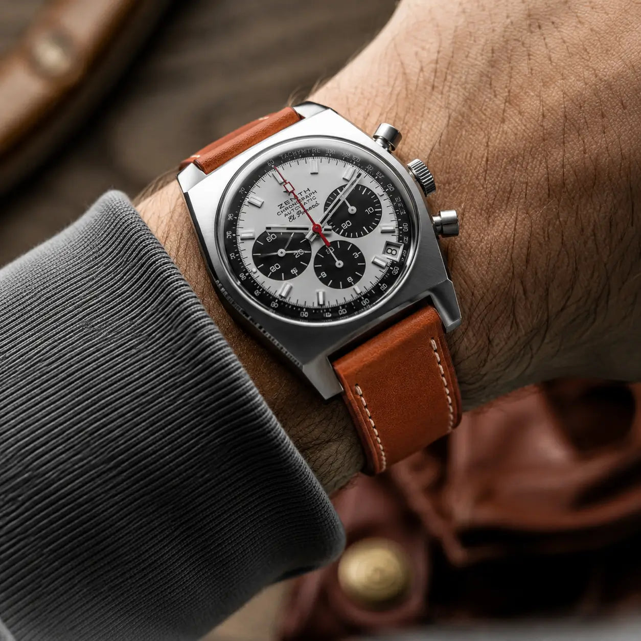 20mm Coral brown leather watch strap fitted on Zenith El Primero Chronograph watch on wrist, handcrafted leather watch band with classic contrast stitching.
