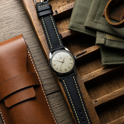 20mm Black Italian leather watch strap paired with vintage Omega Automatic watch, handcrafted premium watch band with yellow contrast stitching and timeless design.