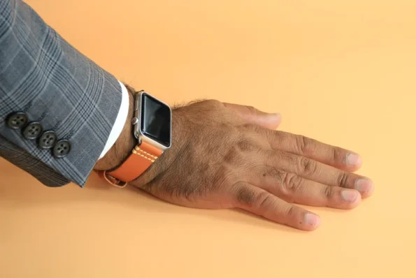 A man wearing Orange Vegetable Tanned Leather Apple Watch Band