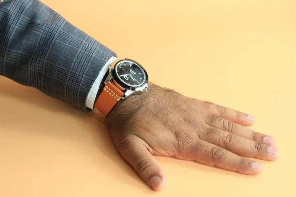 A man is wearing Orange Vegetable Tanned Leather Watch Strap