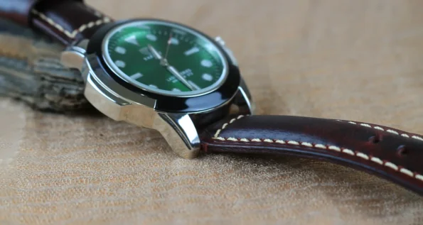 a close up of a watch with leather strap