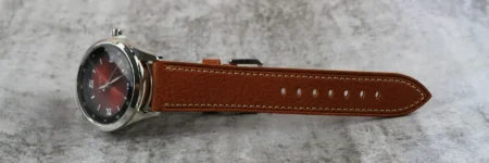 a brown leather strap with a metal buckle